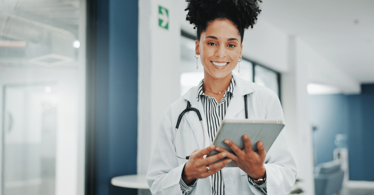 medical data extraction_2 smiling woman with tablet in hospital setting